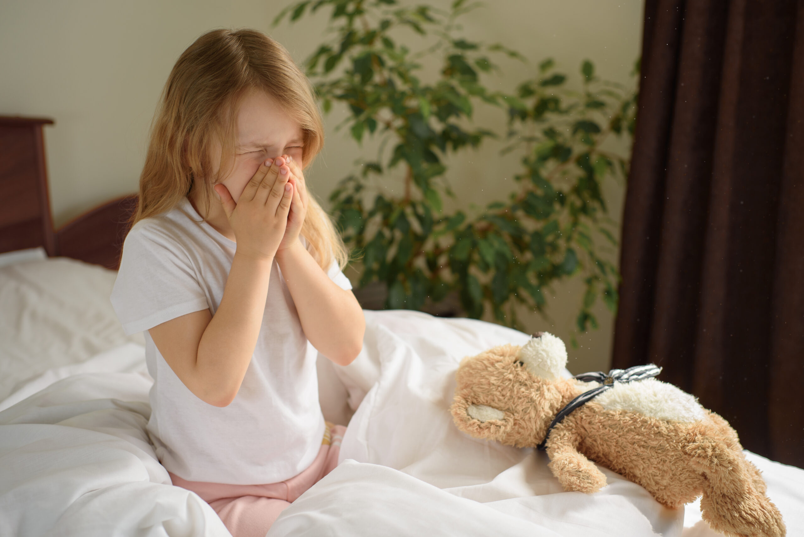A,Little,Girl,Sits,And,Sneezes,On,The,Bed,Among